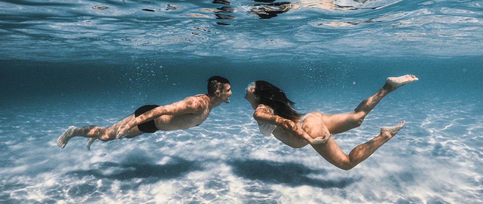 a couple swimming underwater